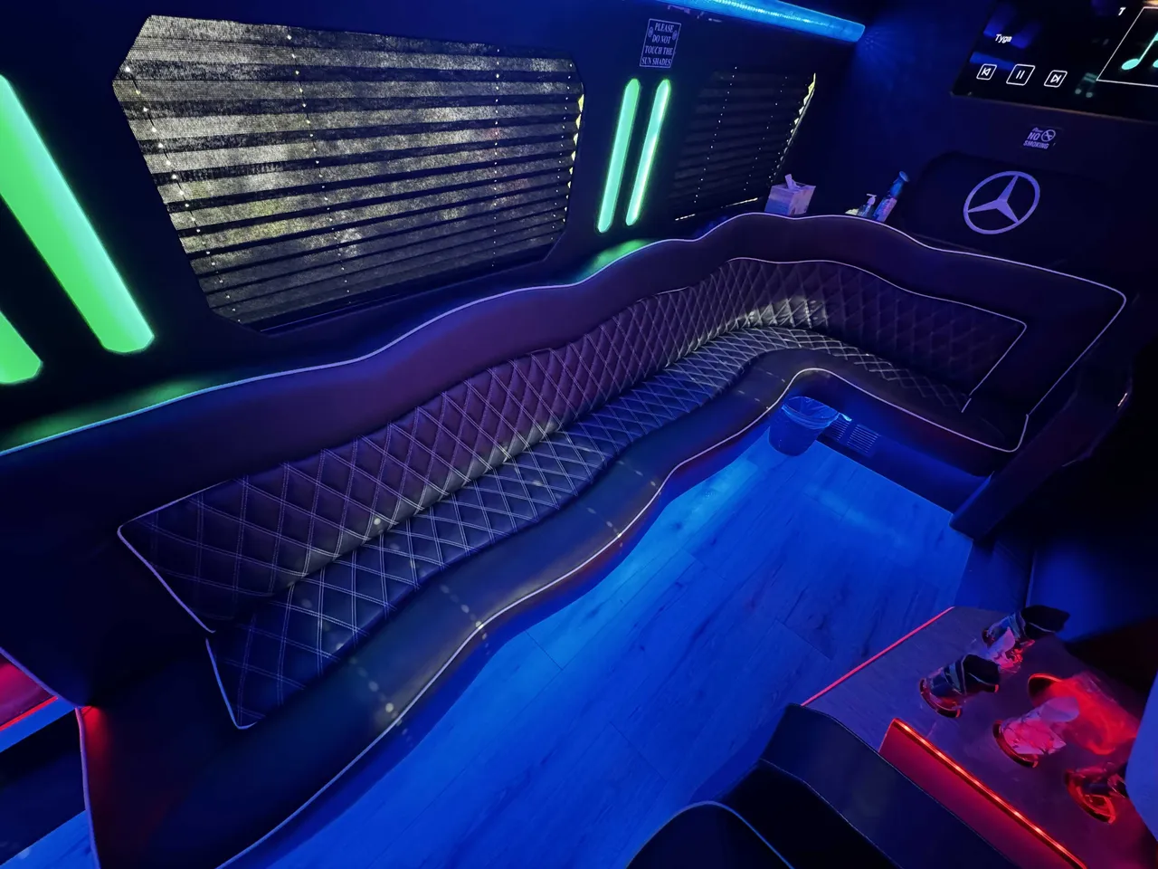 Mercedes-Benz Sprinter Party Limousine Bus interior with perimeter lounge seating, sofa-style seating and passenger tables, photo 6 for bachelorette party transport in Newbury Park, CA Mercedes-Benz Sprinter Party Limousine Bus interior with perimeter lounge seating, sofa-style seating and passenger tables, photo 6 for bachelorette party transport in Newbury Park, CA