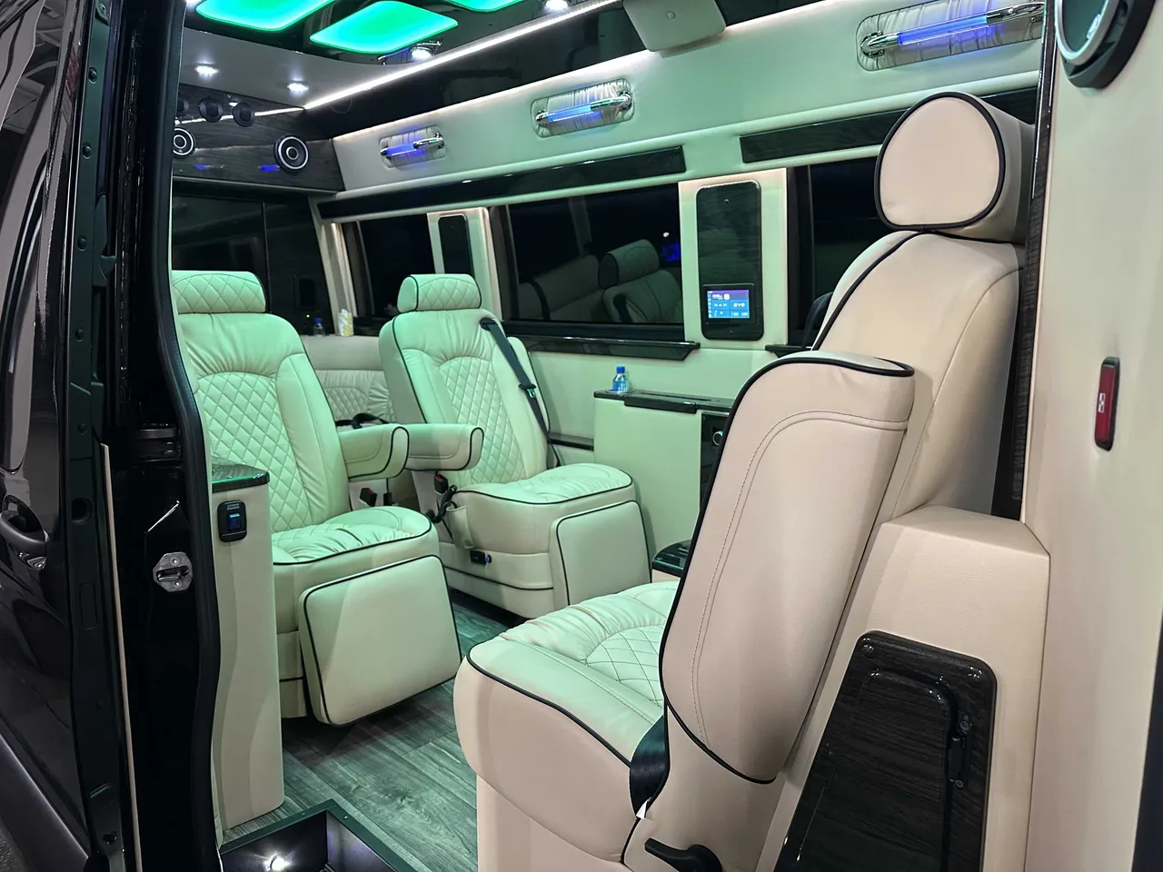 Mercedes-Benz Executive Sprinter interior with captain's chairs, LED accent lighting and LED ceiling lighting for minibus rental