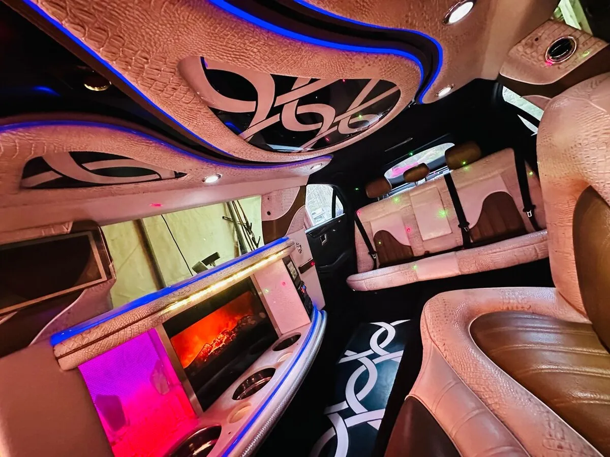 Mercedes-Benz Jet Doors Limousine interior with perimeter lounge seating and LED accent lighting for wedding car rental in North Attleboro, MA