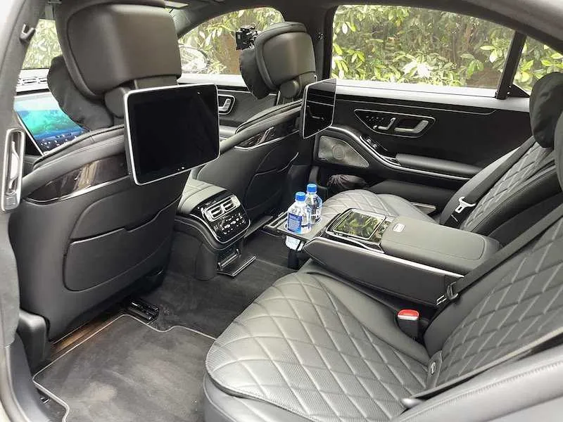 Mercedes-Benz S-Class interior with rear passenger controls and rear-seat entertainment screens for wedding car rental