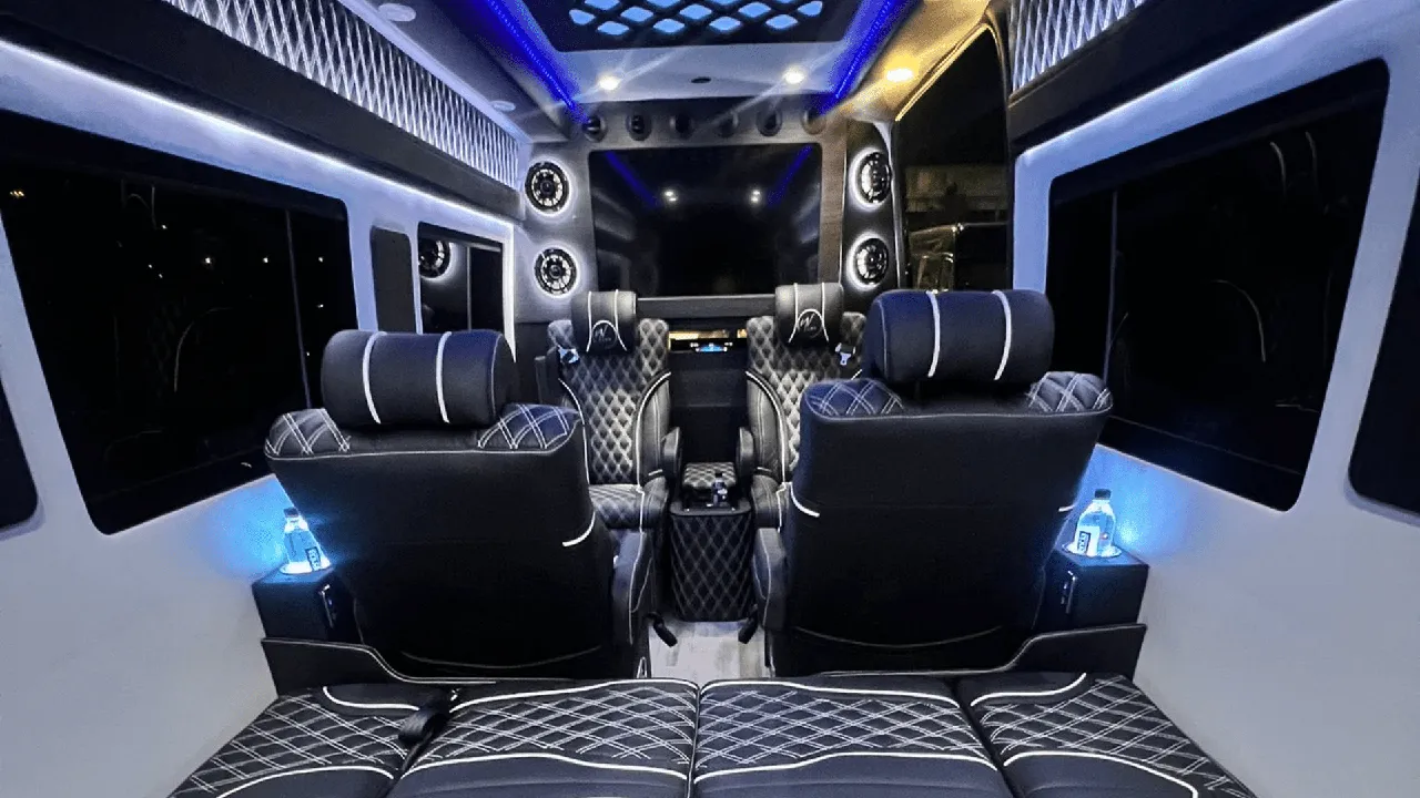 Mercedes Sprinter Jet interior with captain's chairs, cup holders and LED ceiling lighting for mini coach rental in Dalton, MA