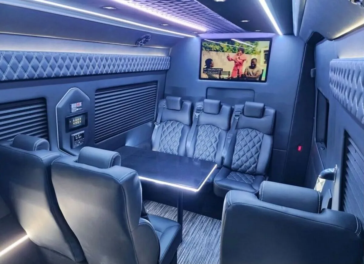 Mercedes Sprinter XL interior with captain's chairs, conference-style seating and passenger tables for winery tour transport in Comstock, NY