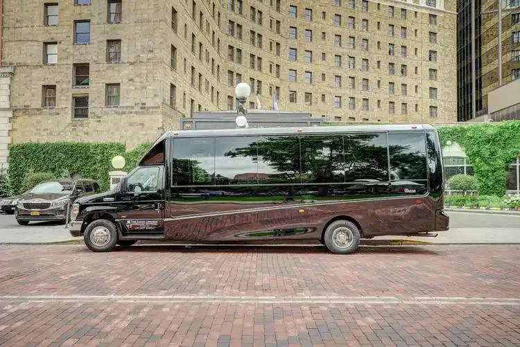 Black 23 Passenger Mini Coach with tinted windows for winery tour transport in Minnesota