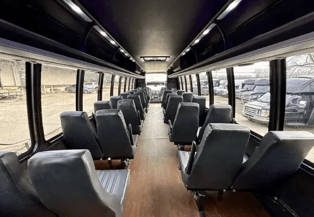 30 Passenger Mini Coach interior with wood-look flooring and overhead parcel racks for minibus rental in San Antonio, TX 30 Passenger Mini Coach interior with wood-look flooring and overhead parcel racks for minibus rental in San Antonio, TX