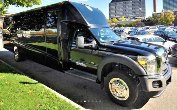Black Mini Coach Limo Bus exterior for party bus rental in Hamburg, IA