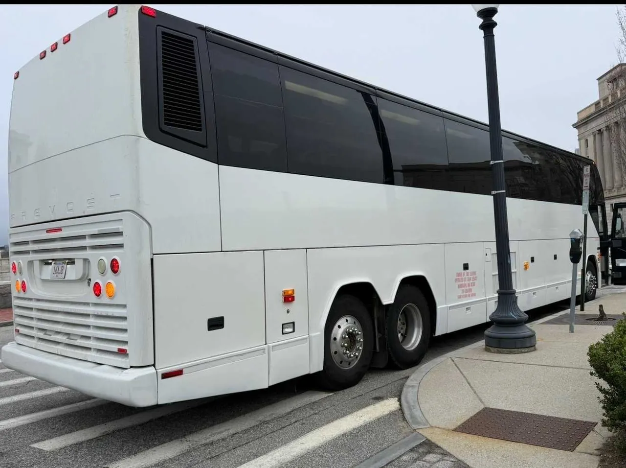 White 55 Passenger Motorcoach exterior with tinted windows, photo 3 for charter bus rental in Clinton, CT