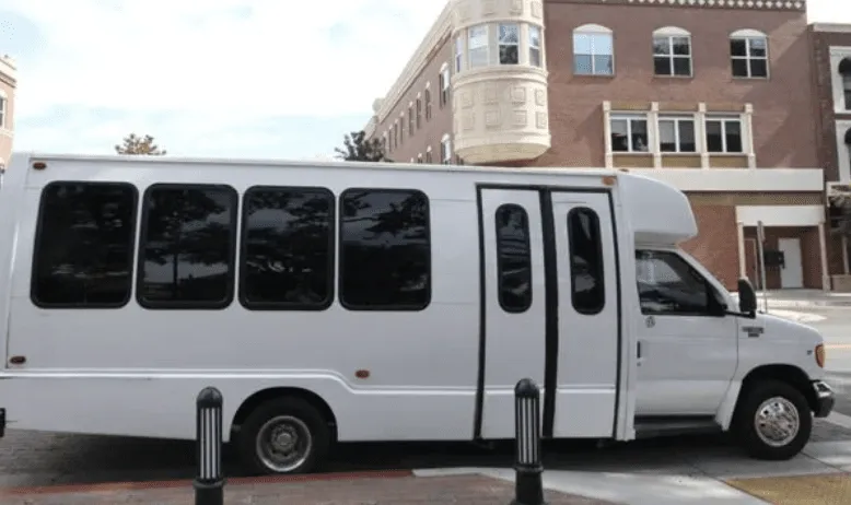 White 16 Passenger Party Bus exterior with tinted windows for bachelorette party transport in Big Pine, CA