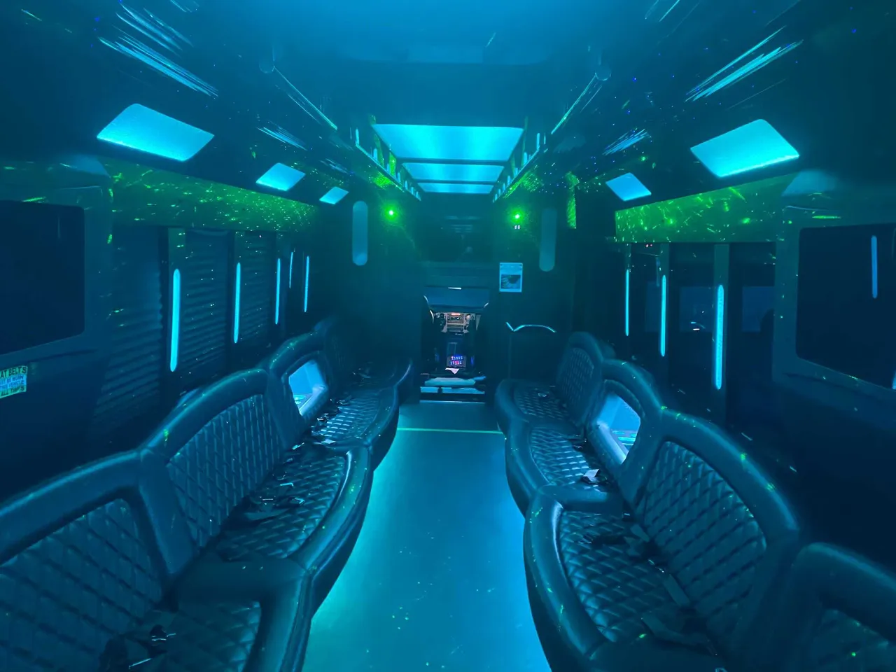 25 Passenger Party Bus interior with perimeter lounge seating, LED accent lighting and LED ceiling lighting, photo 2 for party bus rental