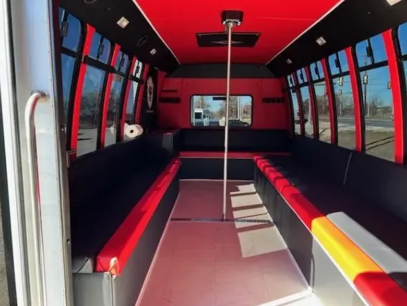 Red Line Party Bus interior with perimeter lounge seating and dance pole for bachelorette party transport in Runge, TX Red Line Party Bus interior with perimeter lounge seating and dance pole for bachelorette party transport in Runge, TX