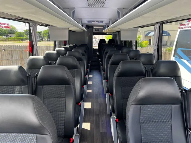 34 Passenger Charter Bus interior with window shades and overhead parcel racks for charter bus rental in Corpus Christi, TX 34 Passenger Charter Bus interior with window shades and overhead parcel racks for charter bus rental in Corpus Christi, TX